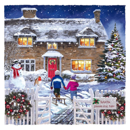Christmas card of a snowy cottage with two people walking up the path